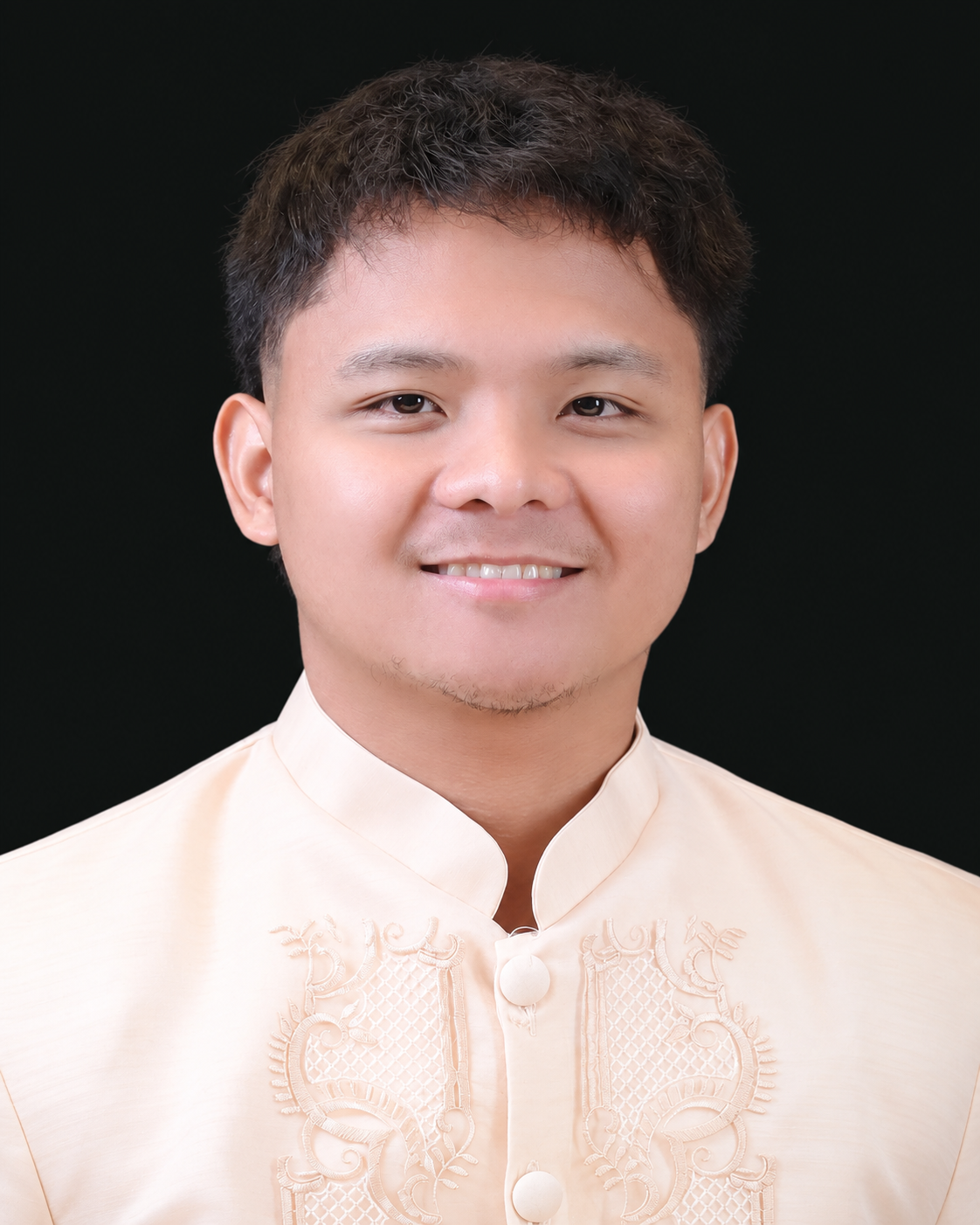 Headshot of Rainzle John Estuesta smiling in a cream barong